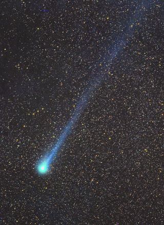 Bright blue streak of a comet across the starry sky