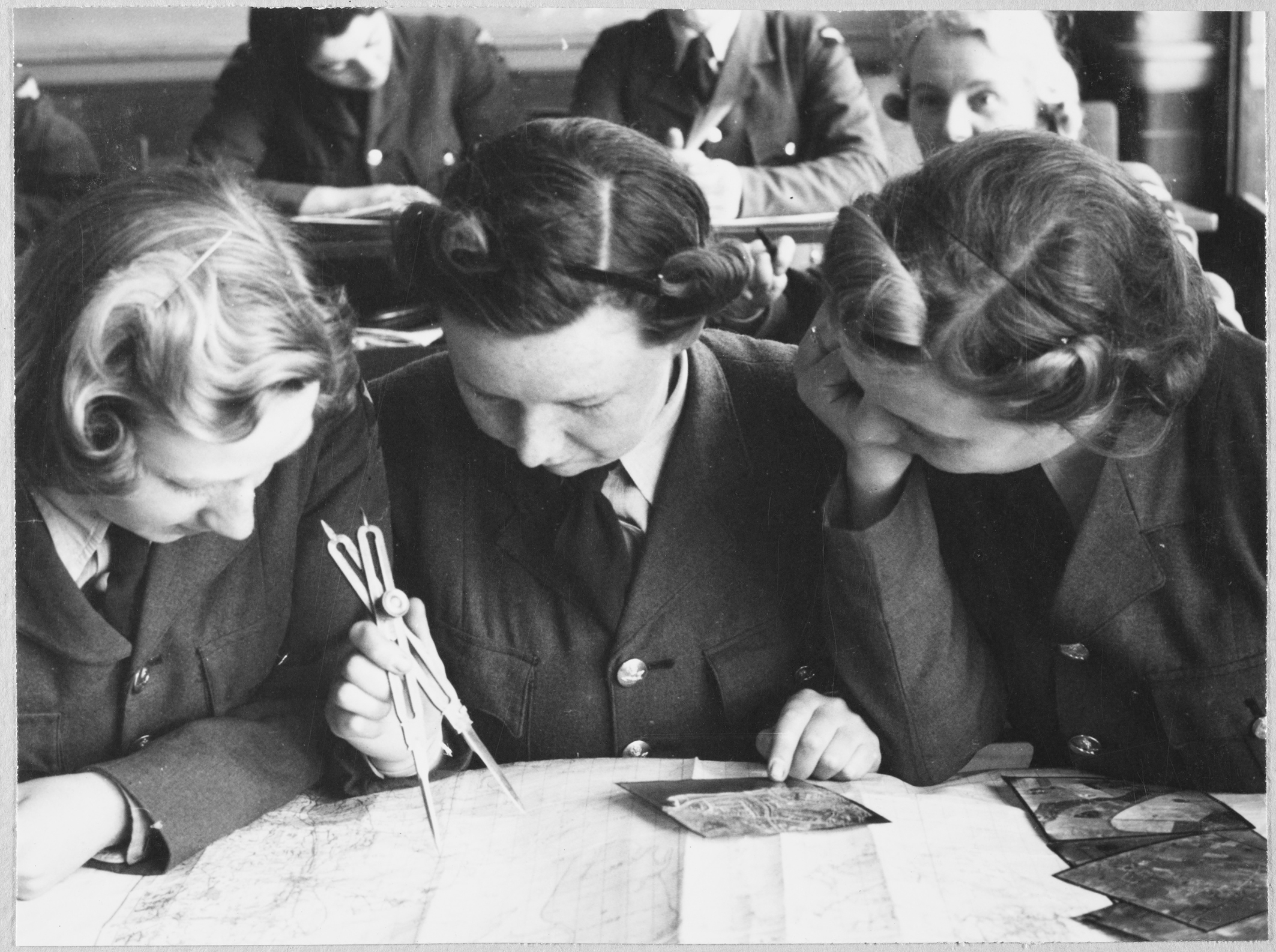 Women's Auxiliary Air Force (WAAF) trainees practising map reading and plotting of aerial photographs, during training at the No.2 School of Photography in Blackpool