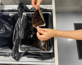 Christina Chrysostomou disposing of spent coffee grounds in trash