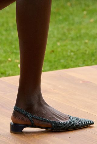 Woven shoe trend shown in Gabriela Hearst's spring 2025 runway show with a model wearing a black slingback woven flat