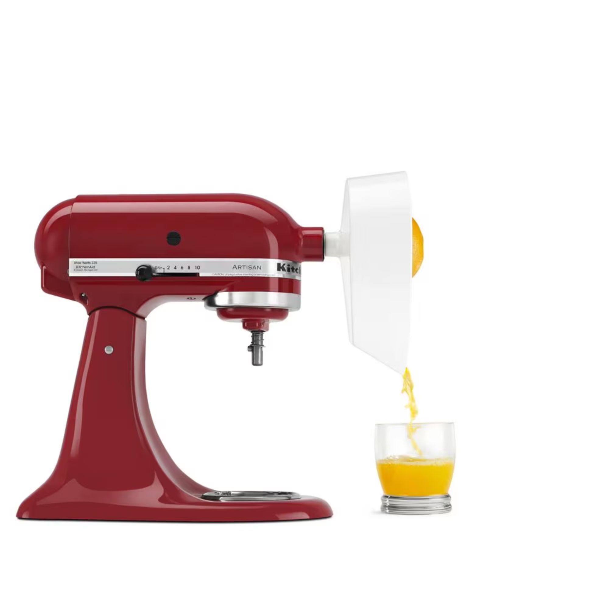 A red KitchenAid Stand Mixer with a white citrus juicing attachment on the front and a glass of orange juice beneath.