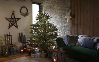 Christmas living room with decorated tree, stars on the walls, presents, green sofa
