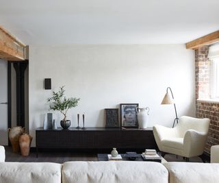 Organic modern living room with a white sofa and dark wood console table