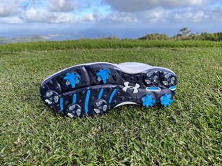 The spike outsole of the Under Armour Drive Pro golf shoe