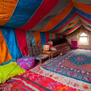 tent room with stripping walls and carpet