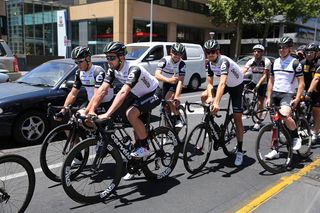 The Dimension Data riders stop at a traffic light