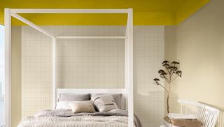 neutral bedroom with a yellow ceiling showing Dulux colour of the year 2025 with a white four poster bed