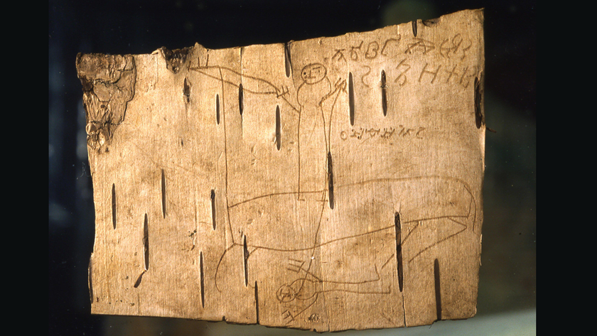 Fragment of birch bark with doodles and Cyrillic letters scratched into it