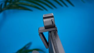 A black Insta360 Link 2C webcam with a magnetic L-shaped mount