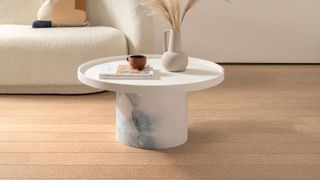 cork flooring in a living room with round white coffee table