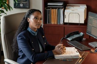 Yaya DaCosta as Andrea Freemann, sitting at her law office desk, in episode 303 of The Lincoln Lawyer