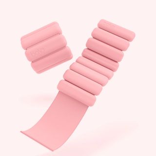 Pair of pink ankle weights on pink background