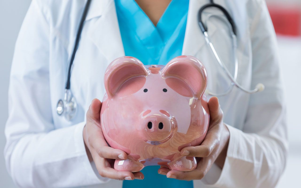 doctor holding a piggy bank