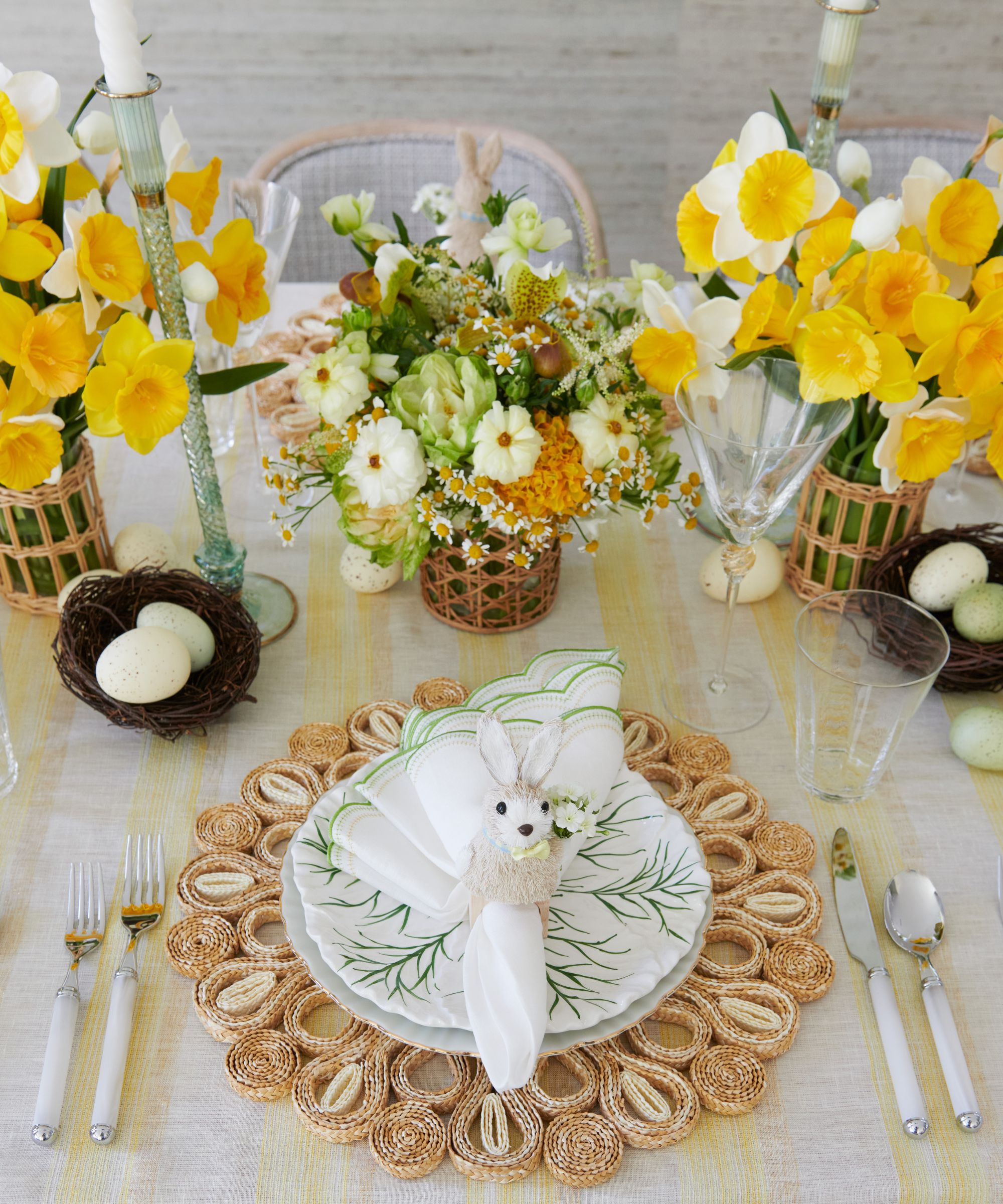 Kim Seybert yellow Easter table styles with rattan placemats, vases, nests and floral centerpieces