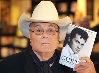 Hollywood legend Tony Curtis with a copy of his autobiography American Prince