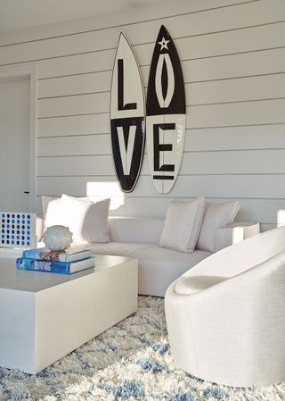 Pool house with white interior and surf board decor