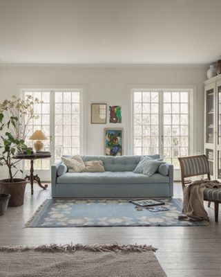 blue sofa in a neutral living room