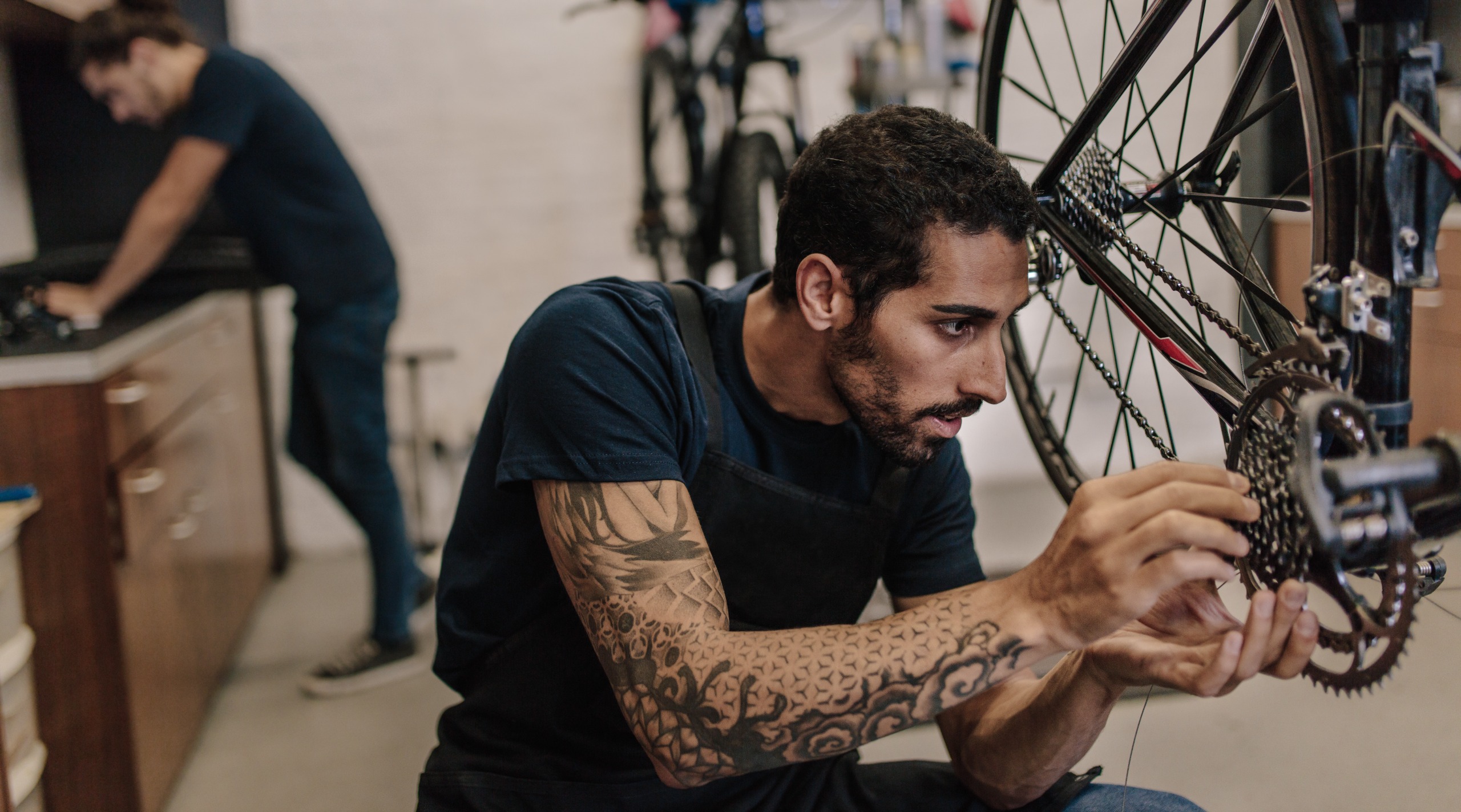 A mechanic works on a road bike drivetrain