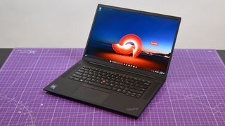 A Lenovo ThinkPad P1 Gen 6 on a table with a purple desk mat underneath