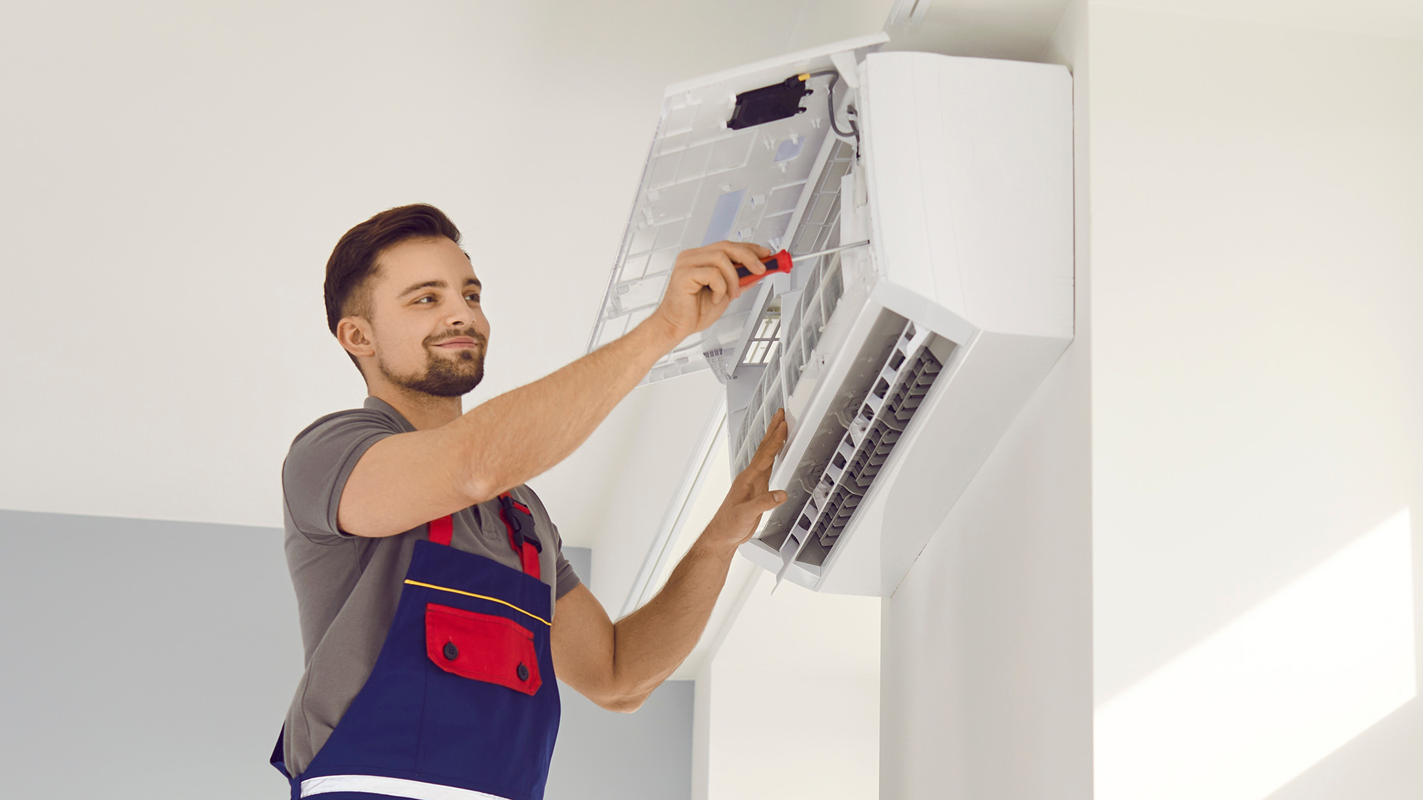 Man servicing air conditioning