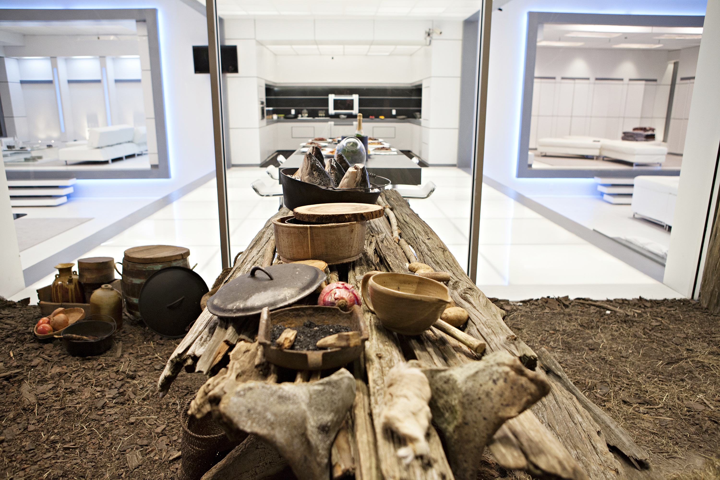 rooms with futuristic looking beds and another room with rustic pots and pans and dirt in a still from the tv show 'Opposite Worlds'