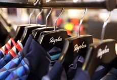 Rapha cycling jerseys hanging on Rapha branded hangers