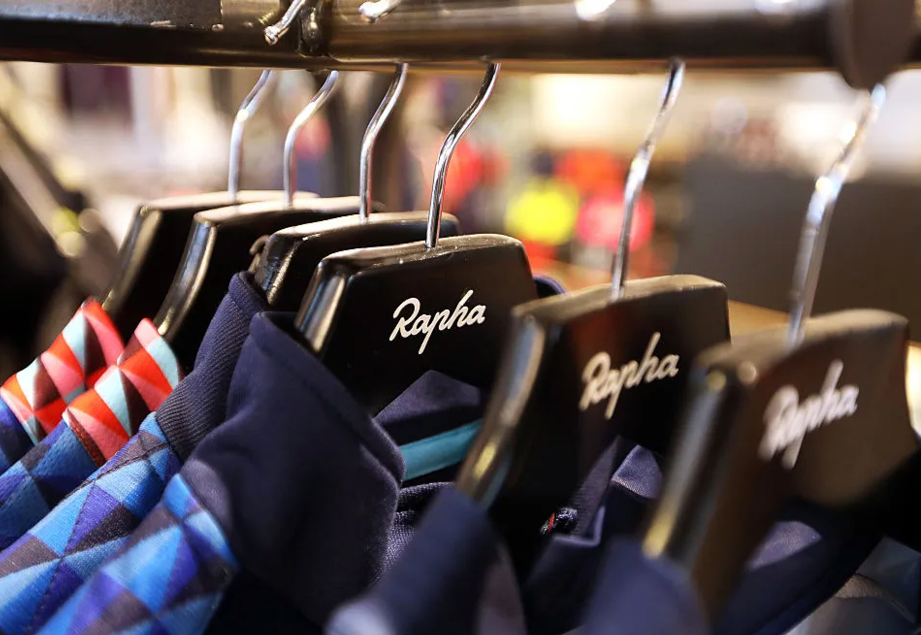 Rapha cycling jerseys hanging on Rapha branded hangers
