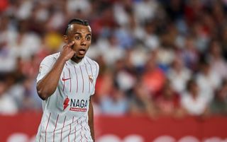 Sevilla defender Jules Kounde, pointing to eye to gesture to teammates to focus