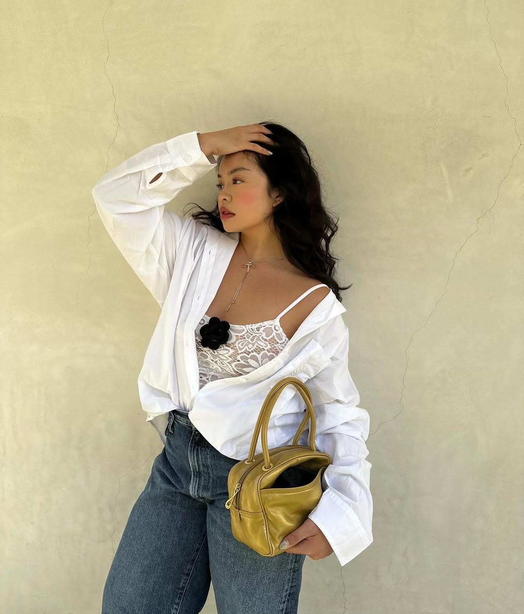 woman wearing jeans and white lace cami tank with button down shirt over it