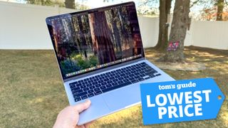 13-inch MacBook Air M4 in hand with Tom's Guide Lowest Price badge