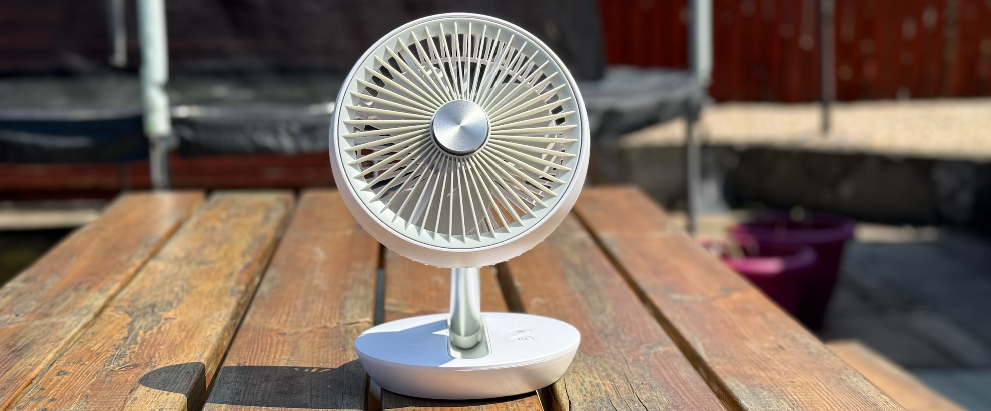 Photo of the Dimplex Rechargeable Cordless Desk Fan on a wooden bench table