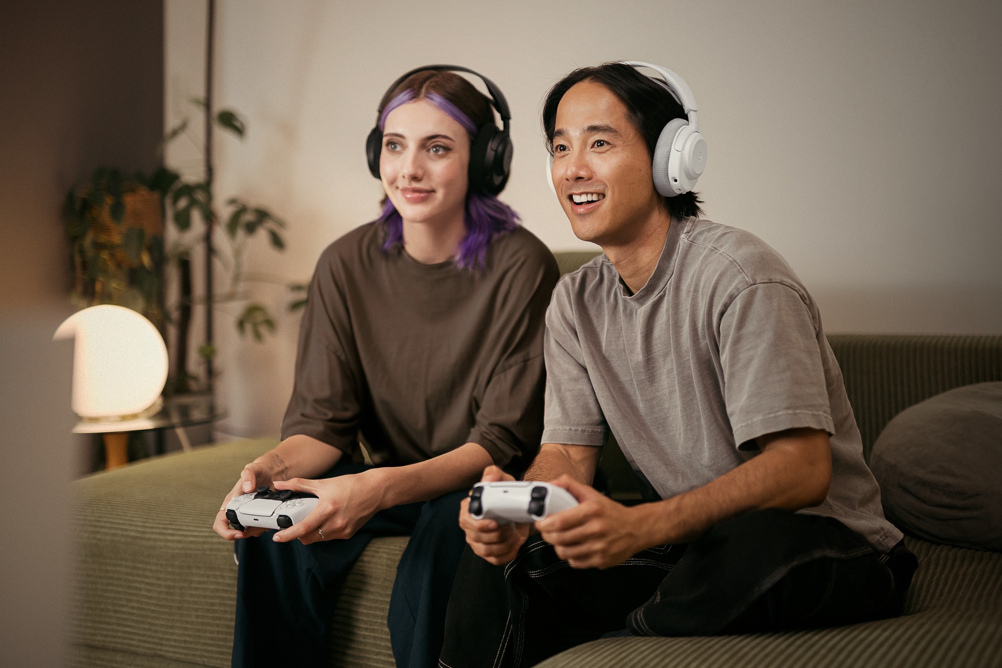Product image of two gamers using the SteelSeries Arctis Nova 3 Wireless headset.