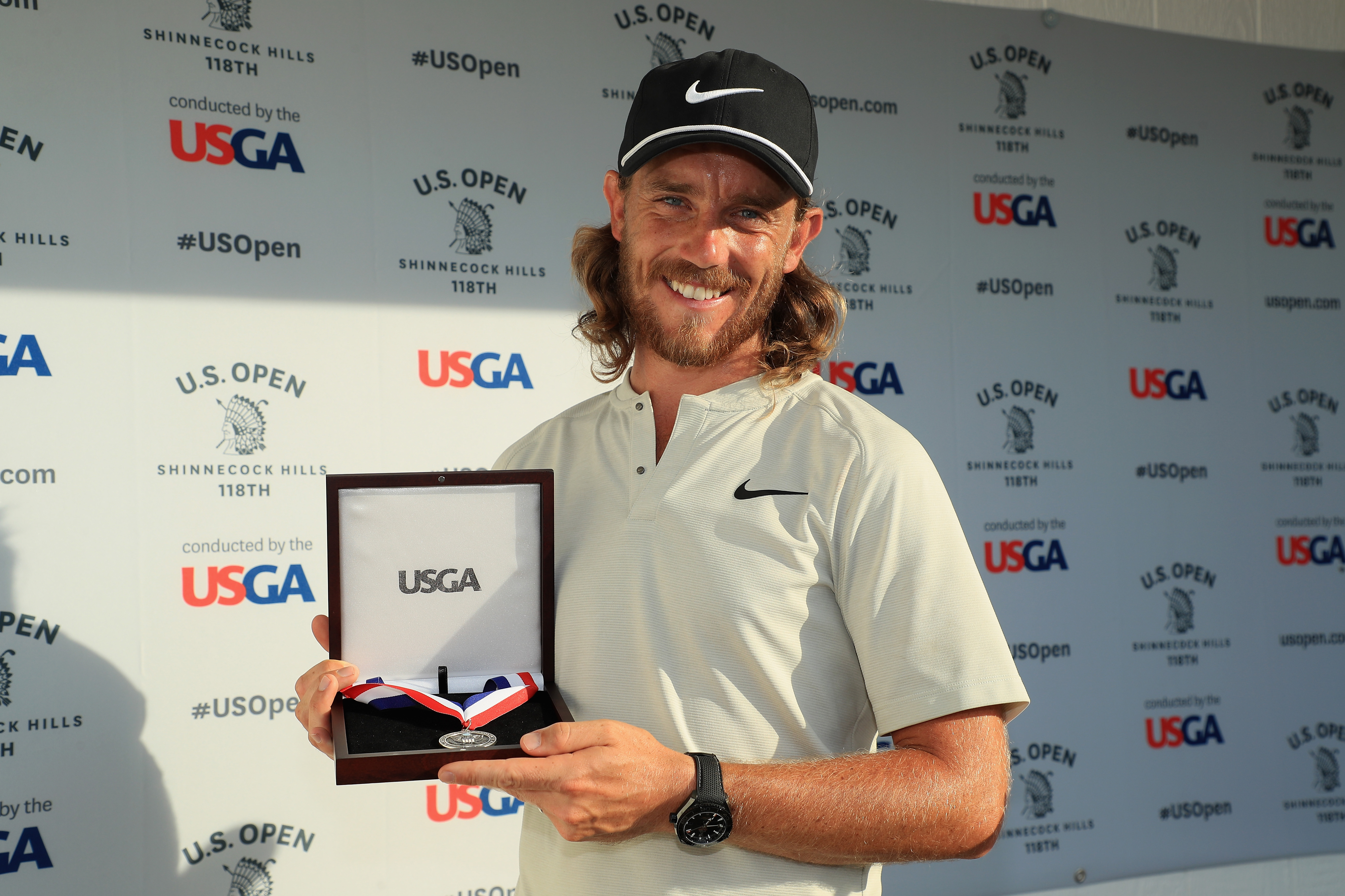 Tommy Fleetwood poses with his runner-up medal after the 2018 US Open at Shinnecock Hills