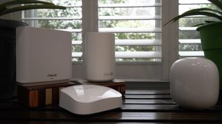 Nest Wifi Pro facing off against ASUS ZenWiFi ET8, TP-Link Deco XE75, and eero Pro 6E on a bench