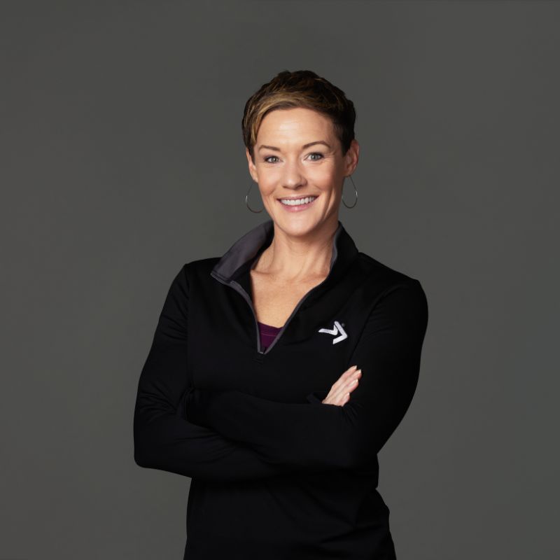 female personal trainer poses for portrait with arms crossed