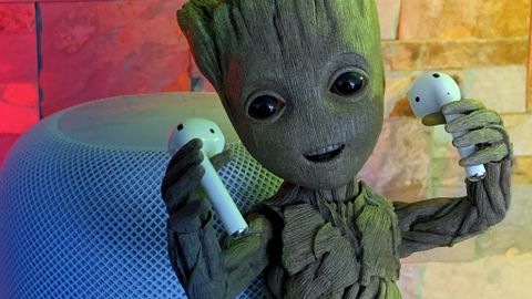 AirPods 2 being held by a Baby Groot statue