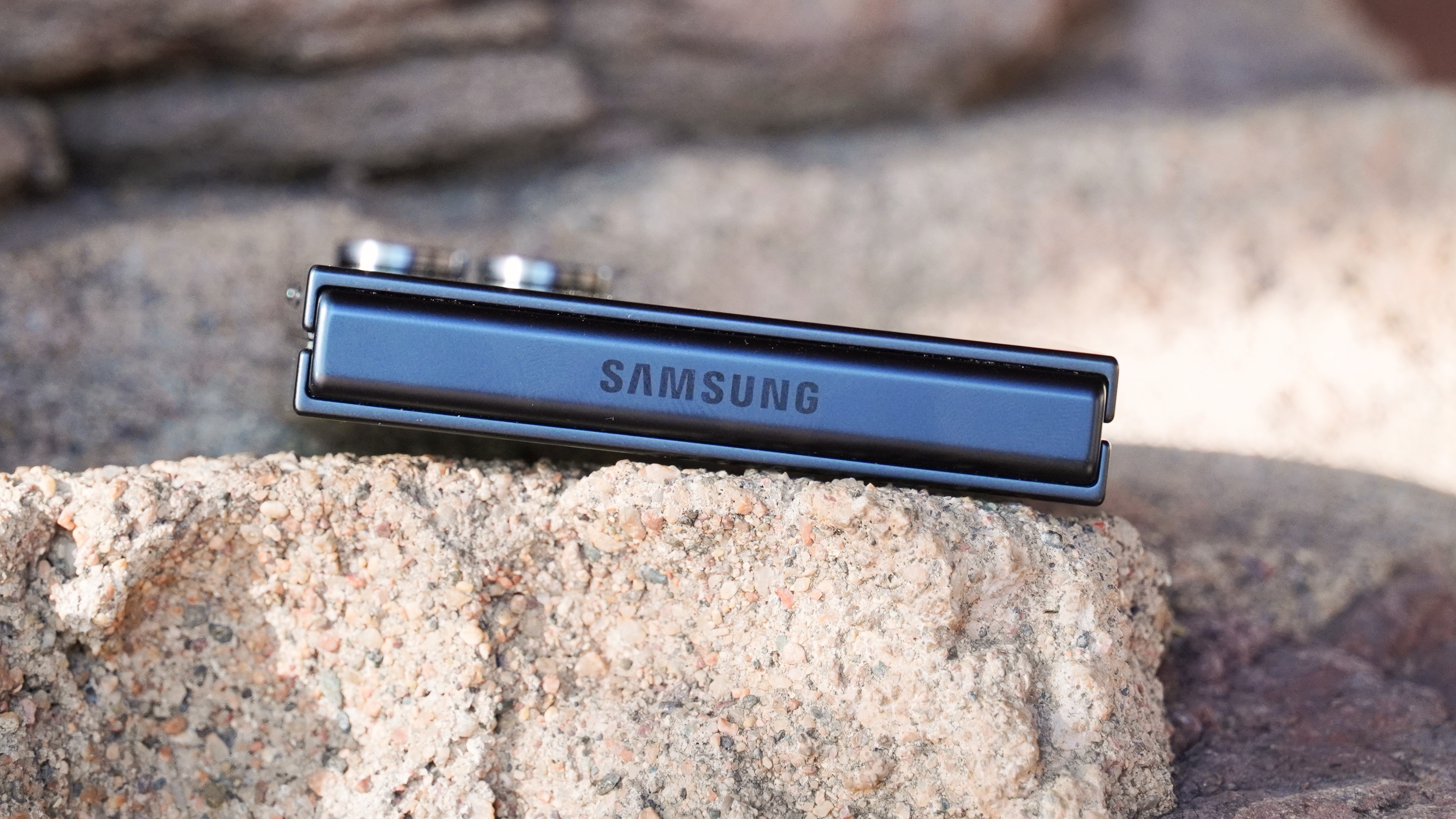 The Samsung Galaxy Z Flip 7 hinge when closed on a rock.