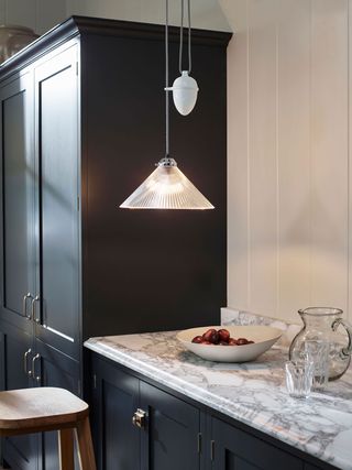 a rise and fall pendant light over a kitchen countertop