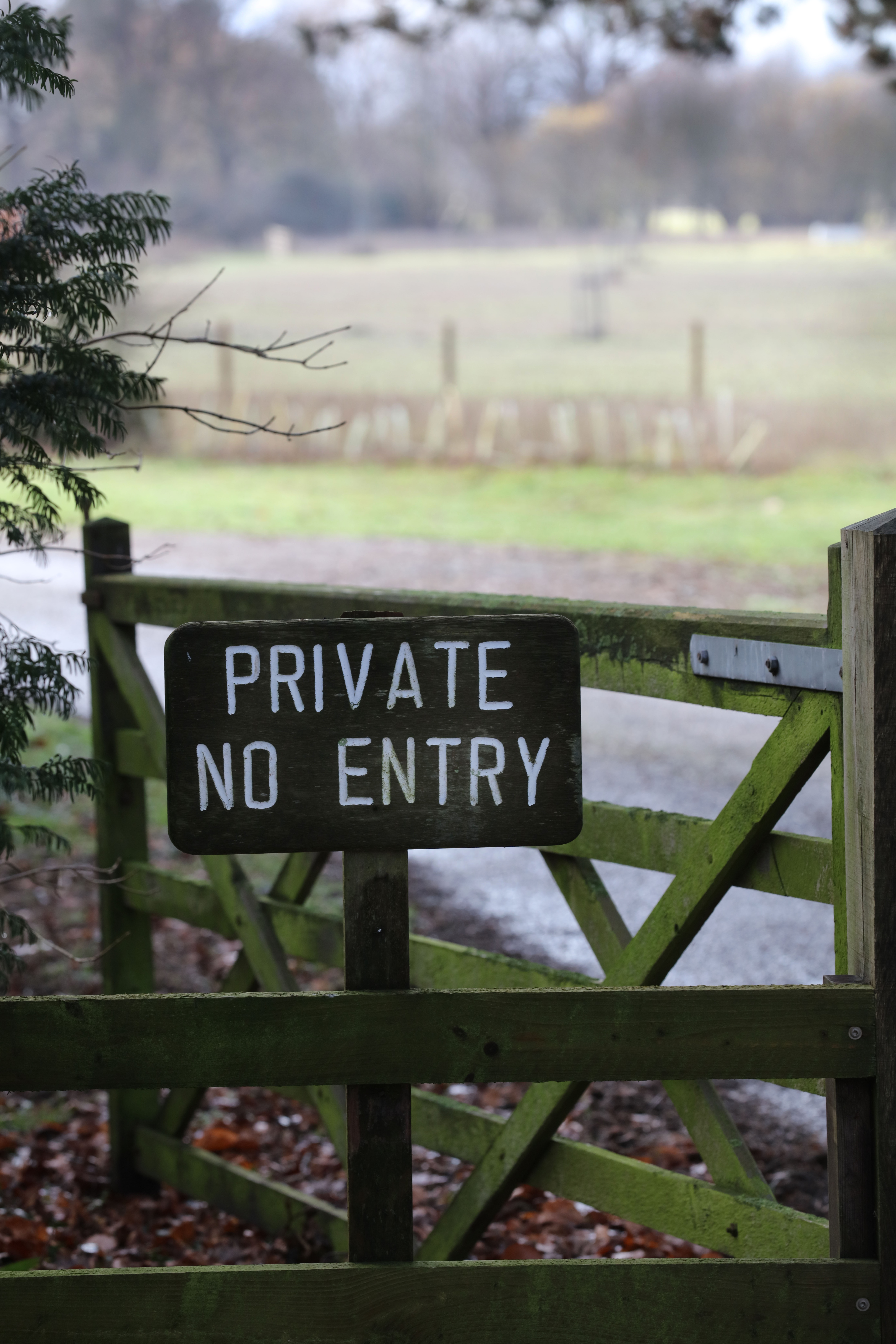 A private no entry sign on a wooden gate