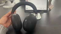 Sonos Ace wireless headphones being held in front of an iPad