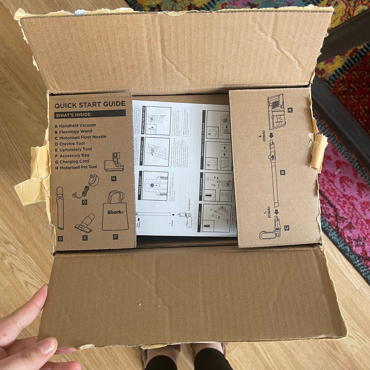 Shark PowerPro Pet Cordless Stick Vacuum box with quick start guide printed on the top of it