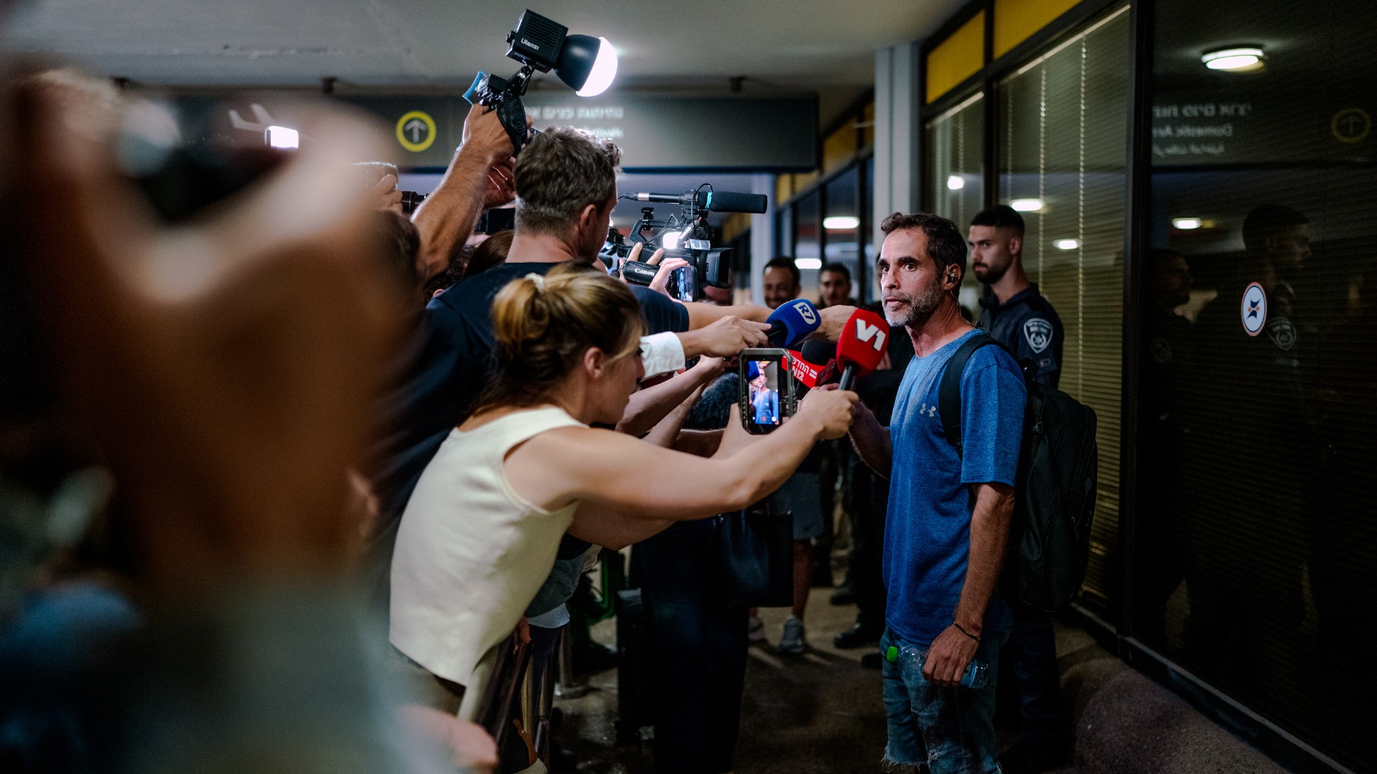 Assaf Regavim, one of the passengers who stormed the flydubai cockpit, speaks to a scrum of reporters outside Ben Gurion Airport 