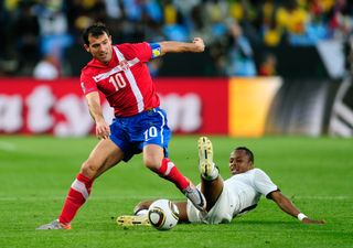 Serbia's Dejan Stankovic evades a challenge from Ghana's Andre Ayew at the 2010 World Cup.
