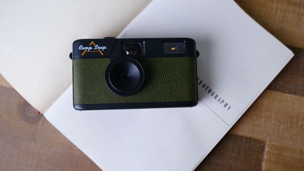 The Camp Snap camera, in forest green, sits on a table