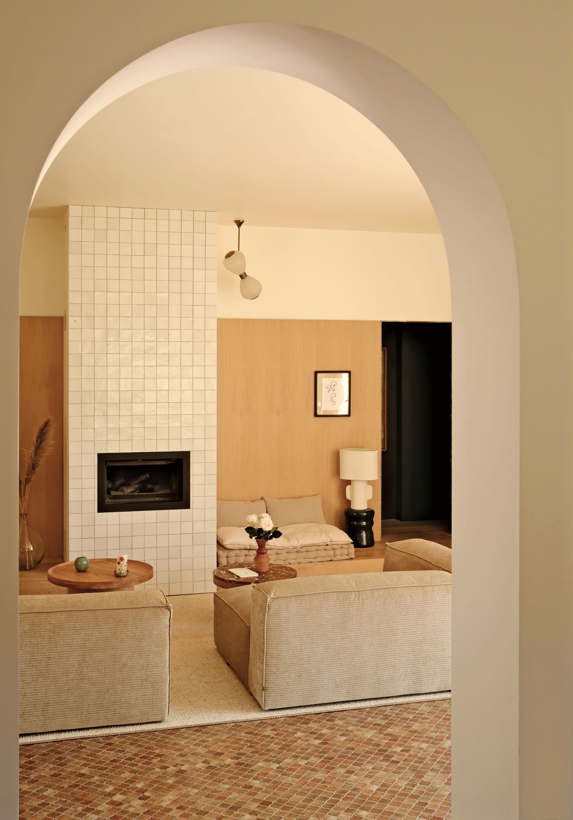 a living room with a tiled chimney breast