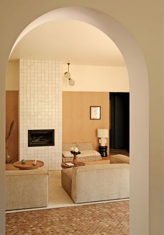 a living room with a tiled chimney breast