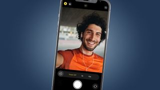 An iPhone screen showing a man taking a selfie
