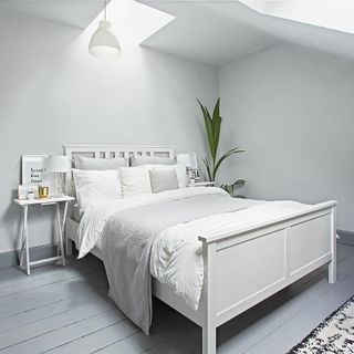 bedroom with wooden flooring and bright white walls