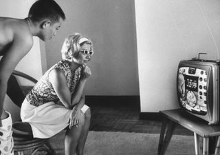 Rene Carpenter with her son on May 24, 1962 watching Scott Carpenter's orbital flight on TV.