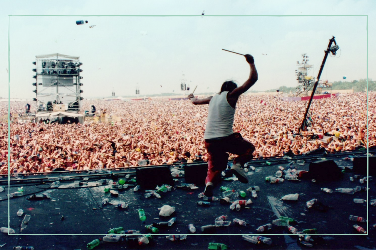 a long shot of the crowd at Woodstock 99 festival backing out from the stage 